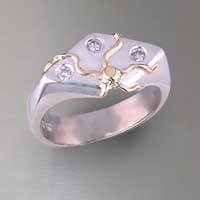 Chevron shape sterling ring with 18k yellow gold accents. 3 round brilliant diamonds = .15 ct. total weight
