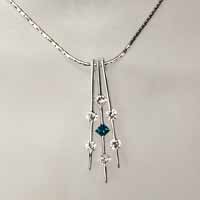 white gold diamond necklace with center blue diamond